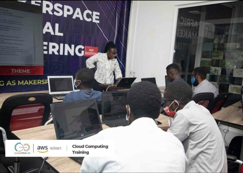 Rita working with participants at their laptops during a Ghana Tech Lab training